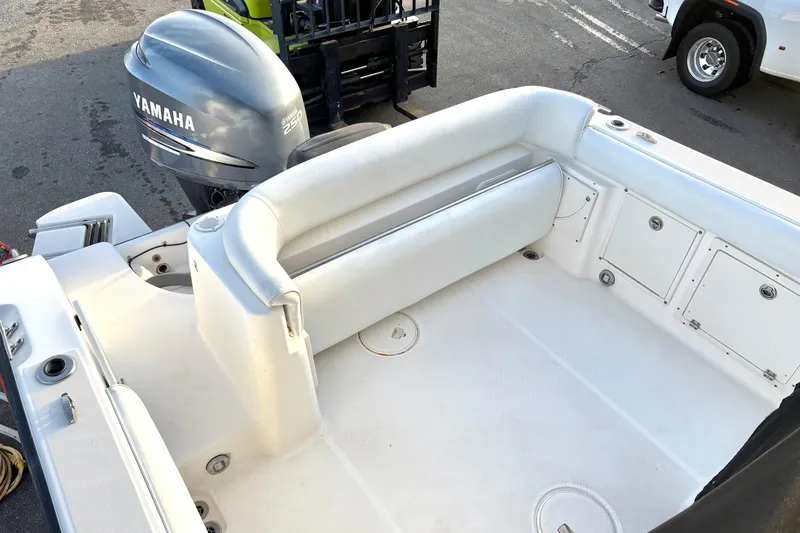 Slide: The Image of 2006 Century 2400 Walkaround boat interior with Yamaha engine, featuring white seating and storage compartments. - 10