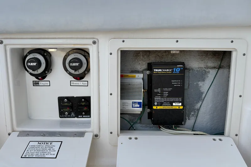 Slide: The Image of Electrical panel of a 2006 Century 2400 Walkaround boat with battery switches and charger. - 13