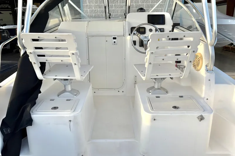 Slide: The Image of 2006 Century 2400 Walkaround boat interior with dual swivel seats and control panel. - 14