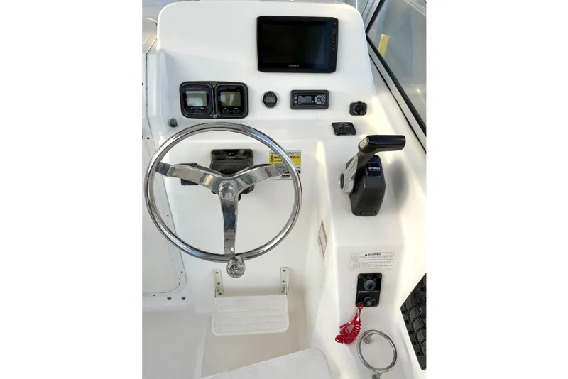 Slide: The Image of Century 2400 Walkaround 2006 boat dashboard with steering wheel and navigation controls. - 15