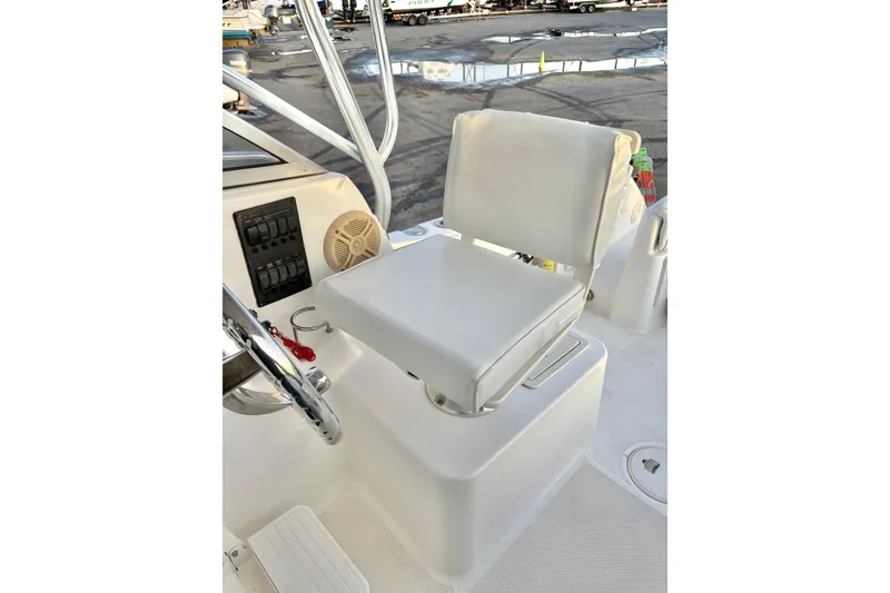Slide: The Image of Century 2400 Walkaround 2006 boat helm seat with steering wheel and control panel. - 16