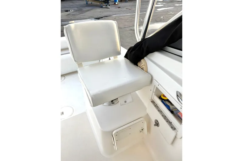 Slide: The Image of Century 2400 Walkaround 2006 boat seat with storage compartment and accessories. - 17