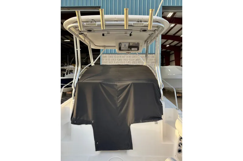 Slide: The Image of 2006 Century 2400 Walkaround boat with covered cockpit, stored indoors. - 19