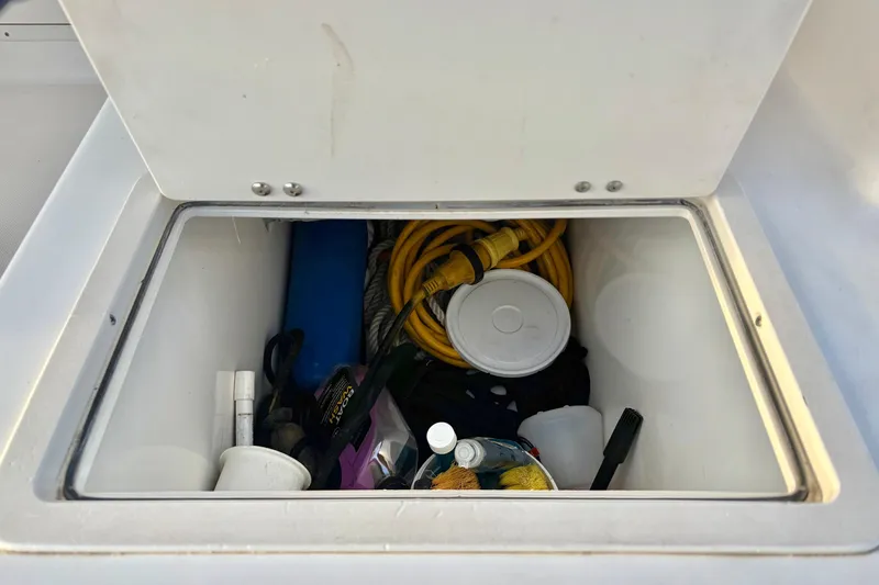 Slide: The Image of Storage compartment on a 2006 Century 2400 Walkaround boat with various equipment. - 20