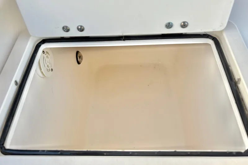 Slide: The Image of Open storage compartment on a 2006 Century 2400 Walkaround boat. - 21