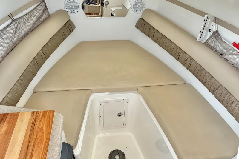 Slide: The Image of Interior cabin of a 2006 Century 2400 Walkaround boat with beige seating and storage. - 22