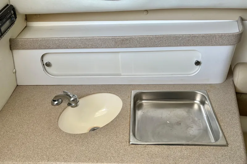 Slide: The Image of 2006 Century 2400 Walkaround boat interior with sink and countertop. - 24
