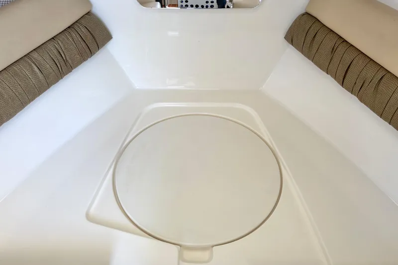Slide: The Image of Interior of a 2006 Century 2400 Walkaround boat with cushioned seating. - 26