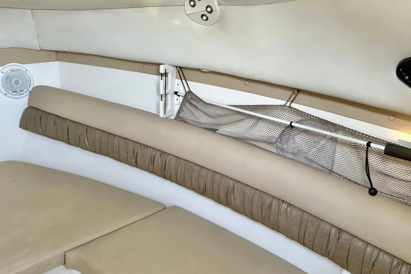 Slide: The Image of Interior cabin of 2006 Century 2400 Walkaround boat with beige seating and storage net. - 27