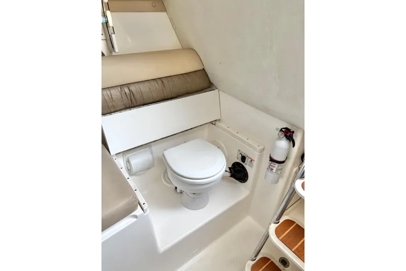 Slide: The Image of 2006 Century 2400 Walkaround boat interior with toilet and fire extinguisher. - 30