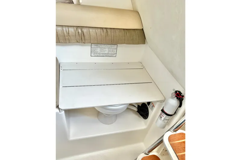 Slide: The Image of 2006 Century 2400 Walkaround boat interior with toilet and fire extinguisher. - 31