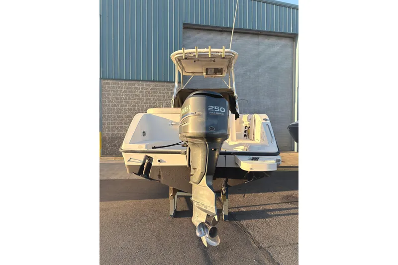 Slide: The Image of 2006 Century 2400 Walkaround boat with Yamaha 250 outboard motor, docked outdoors. - 4