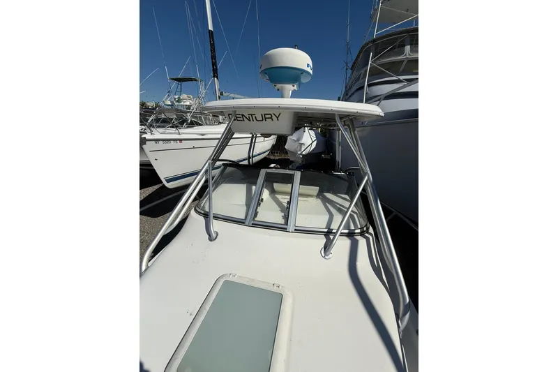 Slide: The Image of 2006 Century 2400 Walkaround boat with radar, docked among other vessels. - 9