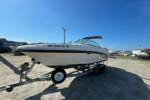 The Image of 2001 Chaparral 230 SSi boat on trailer under clear blue sky. - 0
