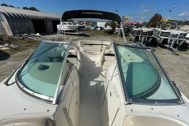 Slide: The Image of 2001 Chaparral 230 SSi boat with open deck and windshield, parked outdoors. - 11