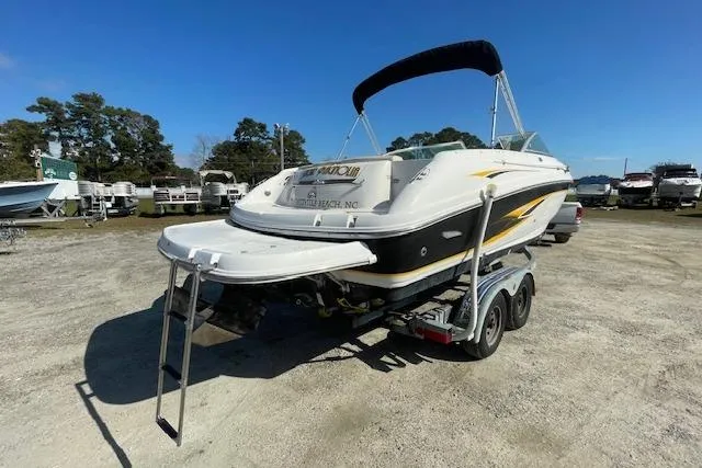 Slide: The Image of 2001 Chaparral 230 SSi boat on trailer, outdoor setting, clear sky. - 4