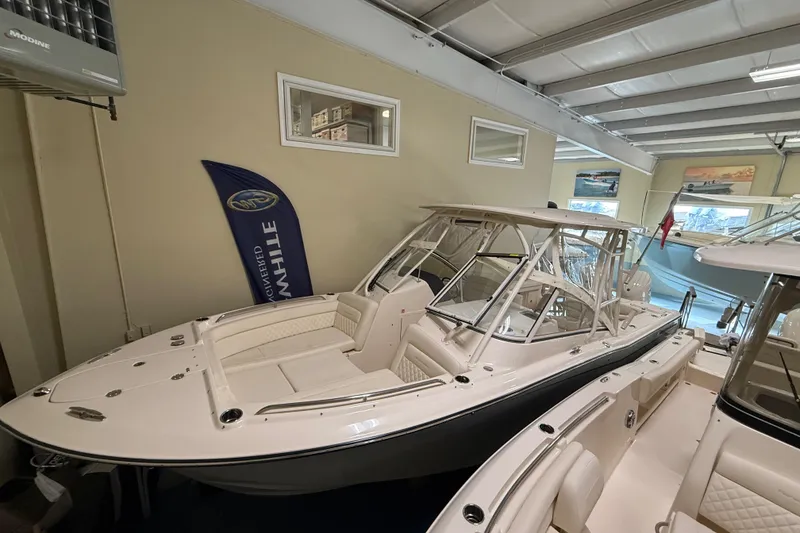 Slide: The Image of 2026 Grady-White Freedom 275 boat displayed in a showroom. - 10