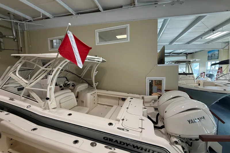 Slide: The Image of 2026 Grady-White Freedom 275 boat with dual Yamaha engines in showroom. - 11