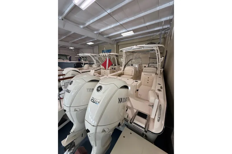 Slide: The Image of 2026 Grady-White Freedom 275 boat with Yamaha engines in showroom. - 12