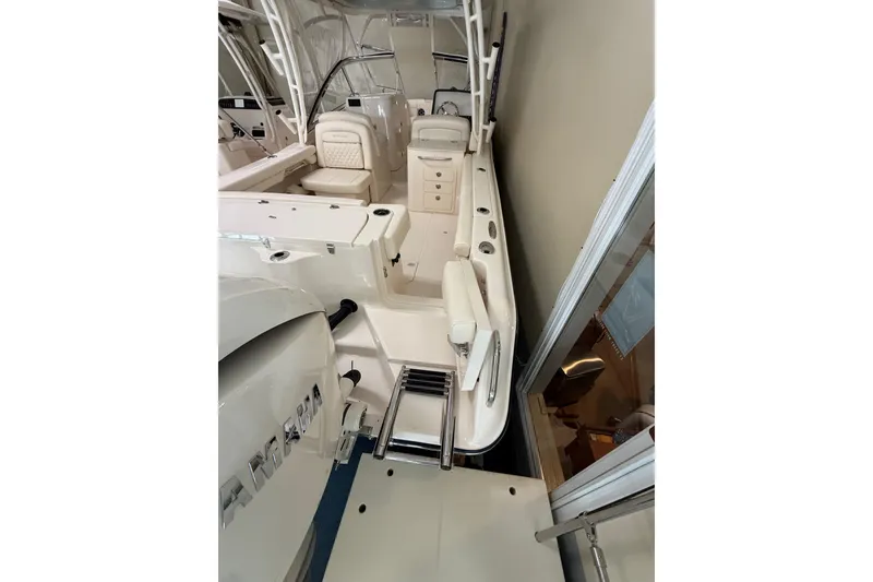 Slide: The Image of 2026 Grady-White Freedom 275 boat interior with seating and ladder. - 13