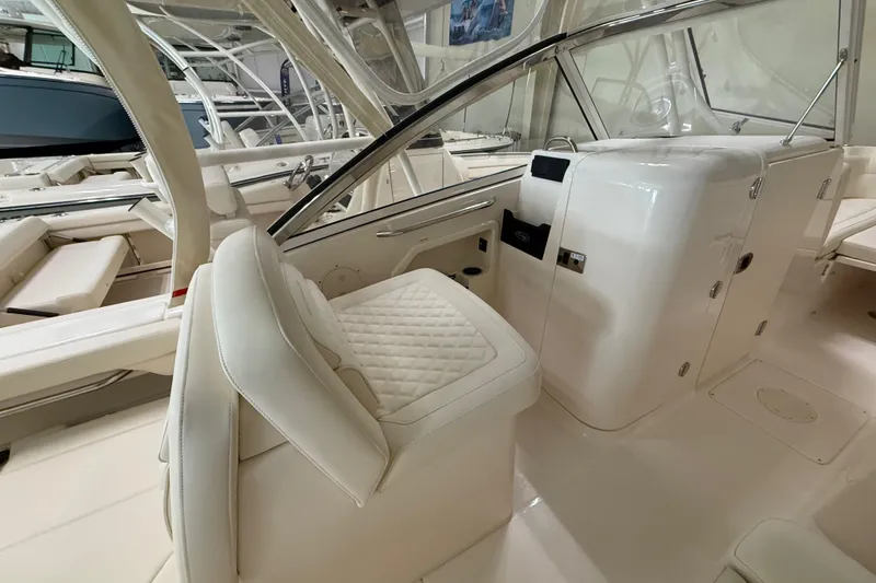 Slide: The Image of 2026 Grady-White Freedom 275 boat interior with luxurious seating and helm station. - 15