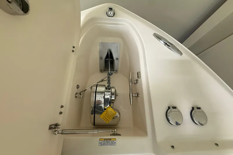 Slide: The Image of Anchor compartment of 2026 Grady-White Freedom 275 boat, featuring stainless steel fittings. - 21