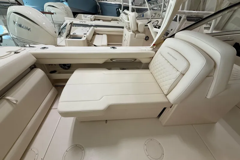 Slide: The Image of 2026 Grady-White Freedom 275 boat interior with luxurious seating and Yamaha engines. - 24