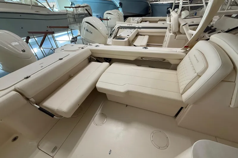 Slide: The Image of 2026 Grady-White Freedom 275 boat interior with luxurious seating and modern design. - 25