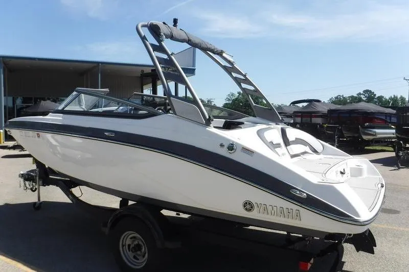 Slide: The Image of 2020 Yamaha Boats 195S on trailer, sleek design, outdoor display. - 12
