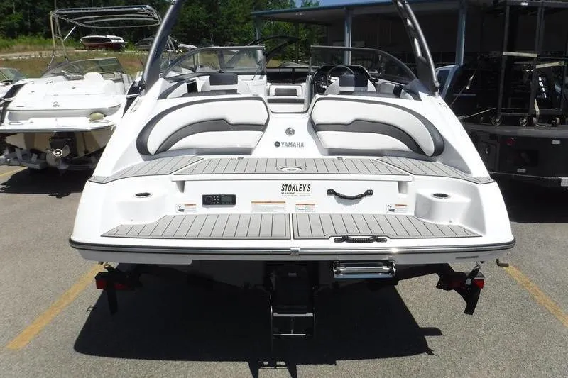 Slide: The Image of 2020 Yamaha Boats 195S, rear view, parked in a marina with other boats. - 13