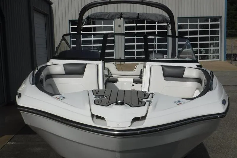 Slide: The Image of 2019 Yamaha Boats AR240, sleek white design, parked near a modern building. - 4