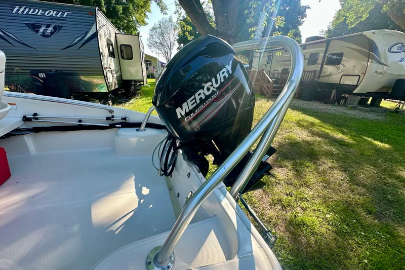 Slide: The Image of 2014 Boston Whaler 150 Super Sport with Mercury engine, parked near RVs in a sunny campground. - 14