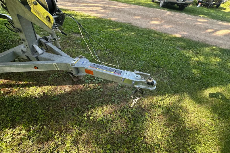 Slide: The Image of Trailer hitch of a 2014 Boston Whaler 150 Super Sport on grassy ground. - 17