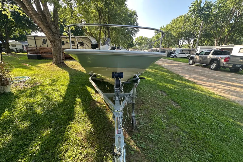 Slide: The Image of 2014 Boston Whaler 150 Super Sport boat on trailer in a grassy area. - 6