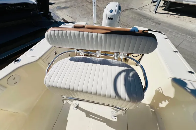 Slide: The Image of 2003 Scout 235 Sportfish boat with white cushioned seating and Suzuki 200 engine. - 10