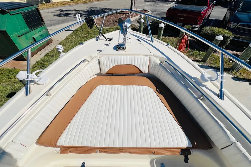 Slide: The Image of 2003 Scout 235 Sportfish boat with cushioned seating and stainless steel railings. - 4