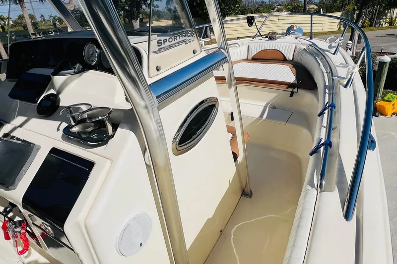 Slide: The Image of 2003 Scout 235 Sportfish boat interior with steering console and seating area. - 6