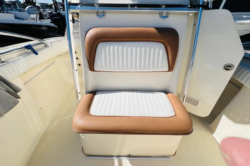 Slide: The Image of 2003 Scout 235 Sportfish boat seat with white and brown upholstery. - 7