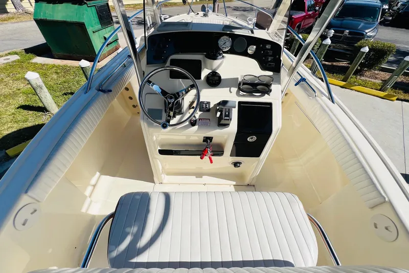 Slide: The Image of 2003 Scout 235 Sportfish boat interior with steering wheel and control panel. - 8