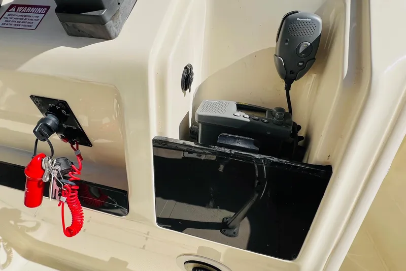 Slide: The Image of 2003 Scout 235 Sportfish boat console with radio and safety equipment. - 9