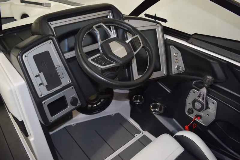 Slide: The Image of 2023 Supra SA boat dashboard with steering wheel and control panel. - 11