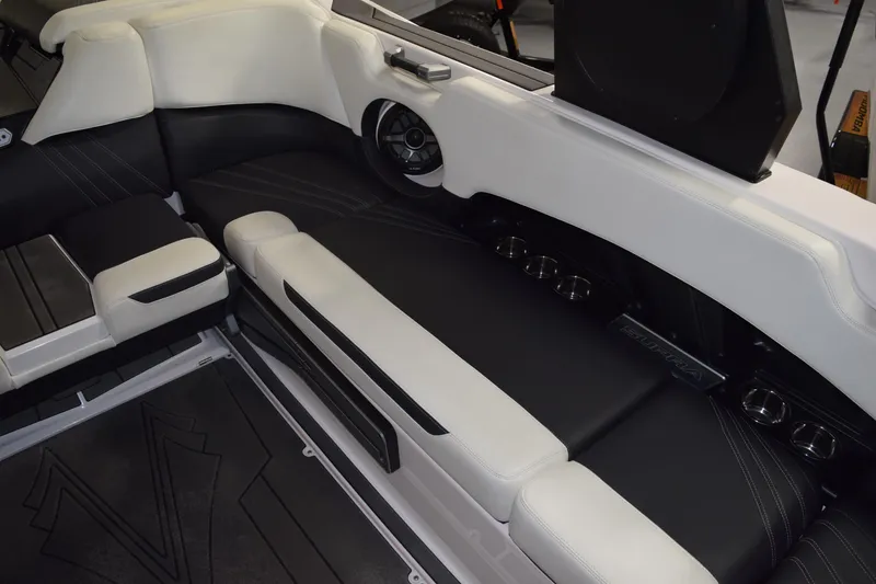 Slide: The Image of 2023 Supra SA boat interior with black and white seating, cup holders, and speaker system. - 13