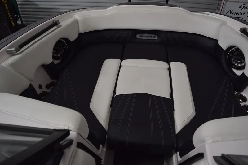 Slide: The Image of 2023 Supra SA boat interior with black and white seating and integrated speakers. - 15