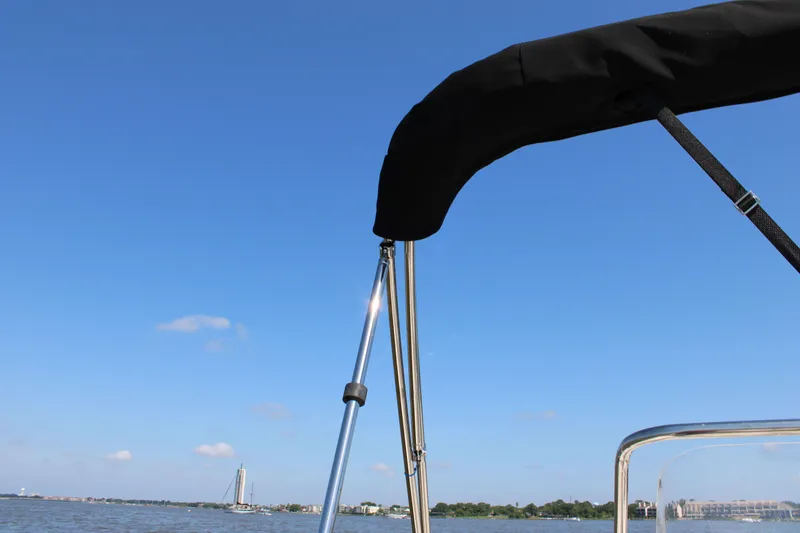 Slide: The Image of Boston Whaler 150 Montauk 2026 on calm water under blue sky. - 17