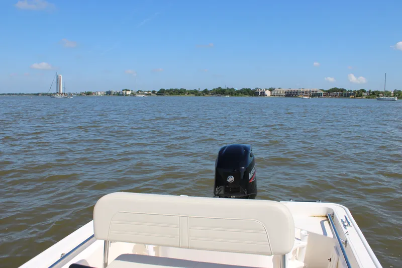 Slide: The Image of Boston Whaler 150 Montauk 2026 on calm waters with city view. - 19