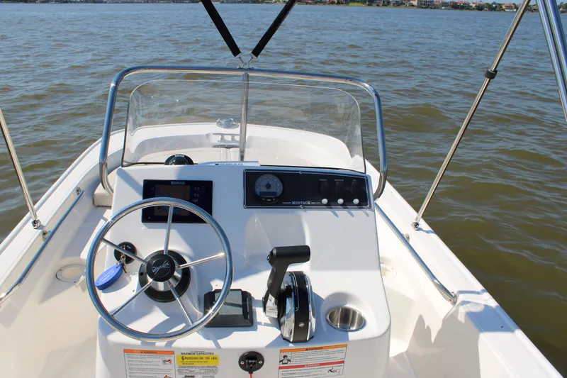 Slide: The Image of Boston Whaler 150 Montauk 2026 helm on open water. - 21