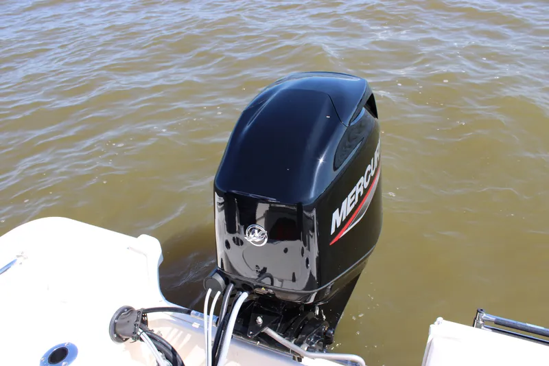 Slide: The Image of 2026 Boston Whaler 150 Montauk with Mercury outboard motor on water. - 22