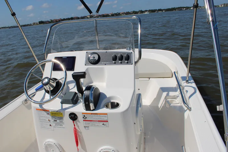 Slide: The Image of Boston Whaler 150 Montauk 2026 helm on calm waters. - 26