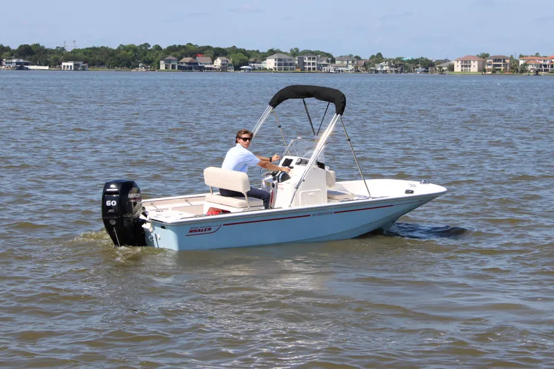 Slide: The Image of 2026 Boston Whaler 150 Montauk on calm waters. - 7