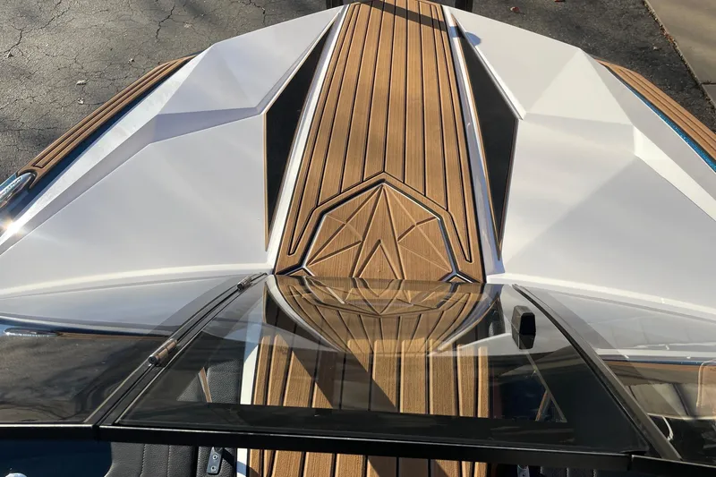 Slide: The Image of 2023 Nautique Ski Nautique boat with sleek design and wood accents. - 10